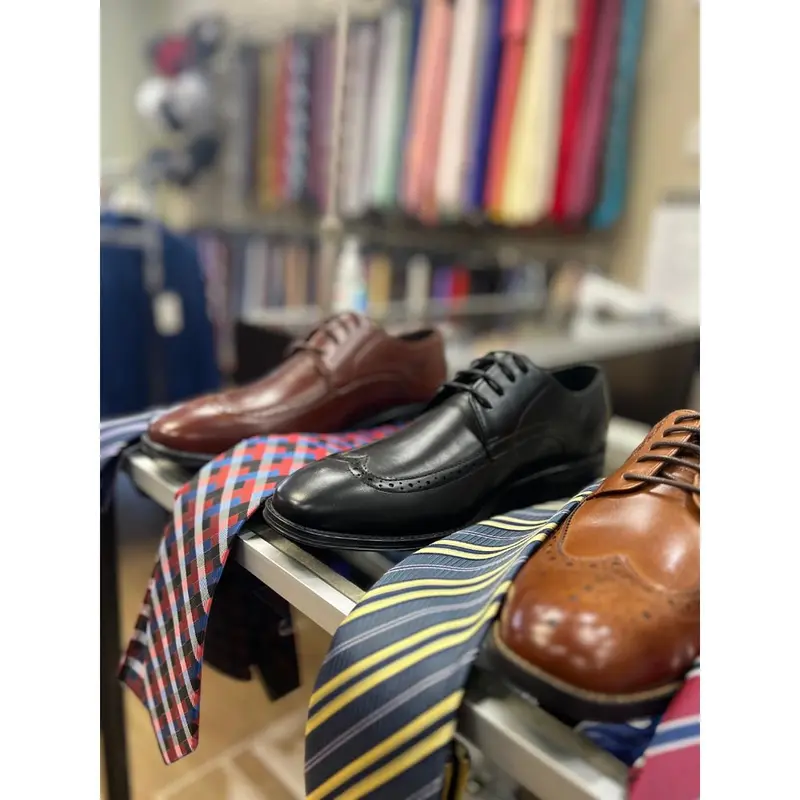 Dress shoes and striped ties on display at Suit Zone