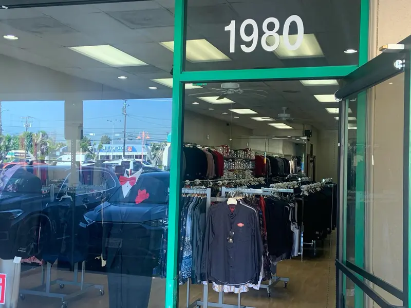 Suit Zone's glass door on N Tustin St with the number 1980 and suits visible inside