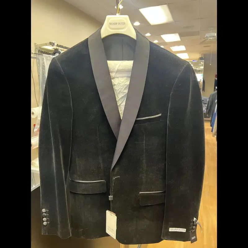 A black velvet shawl-collar tuxedo jacket on a hanger at Suit Zone